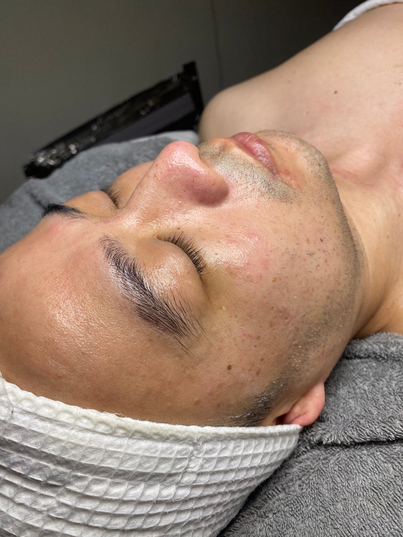 Man receiving a facial treatment with headband on his head