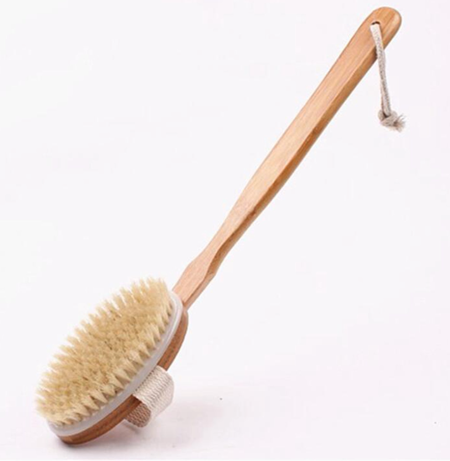 Bath brush with wooden handle and natural bristles on a white background